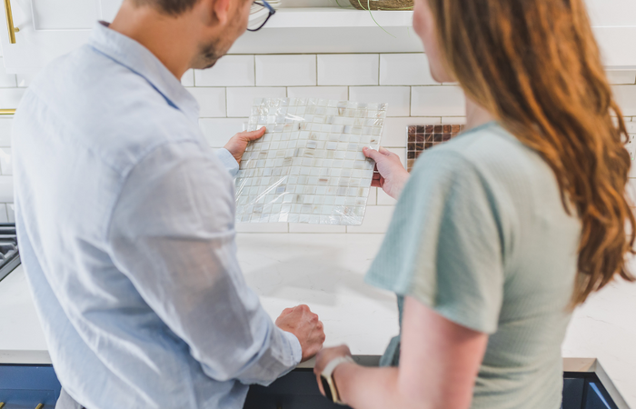 couple choosing backsplash for kitchen remodel