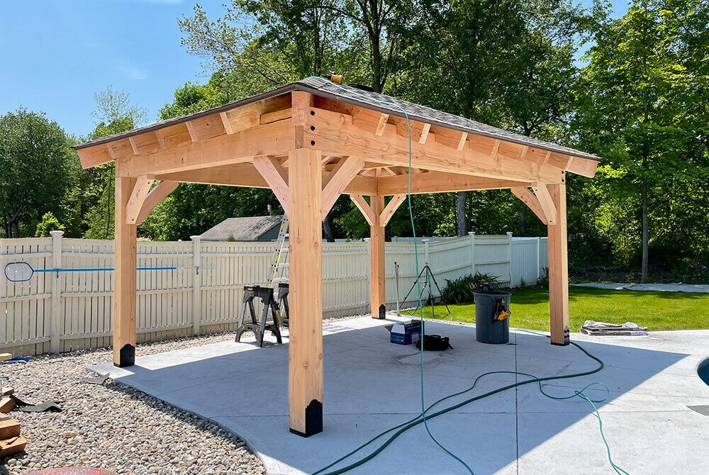 Wooden covered pergola on outdoor patio