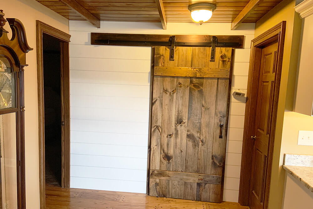 sliding wooden style barn door in interior space