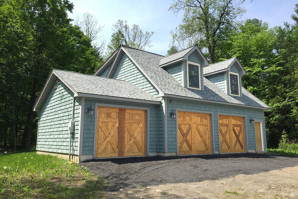 Detached two story garage with three garage bay doors
