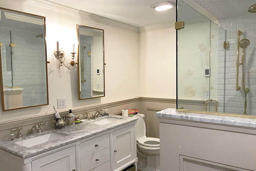 bathroom with white walls and marble countertops in double vanity