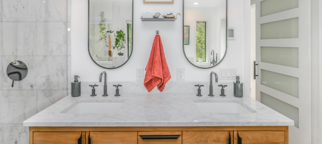 Bright modern bathroom with dual sinks, marble surface, and clean minimalist design.