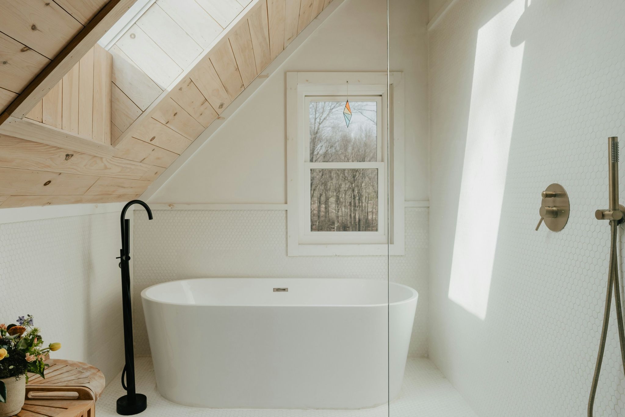Modern kitchen with white island, wood cabinets, and gray shaker cabinets